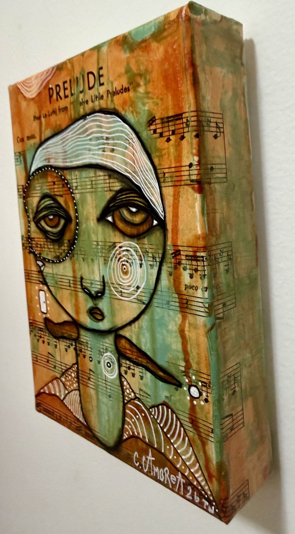 Angled side view of mixed media painting showing canvas edge, textured surface, and painted figure