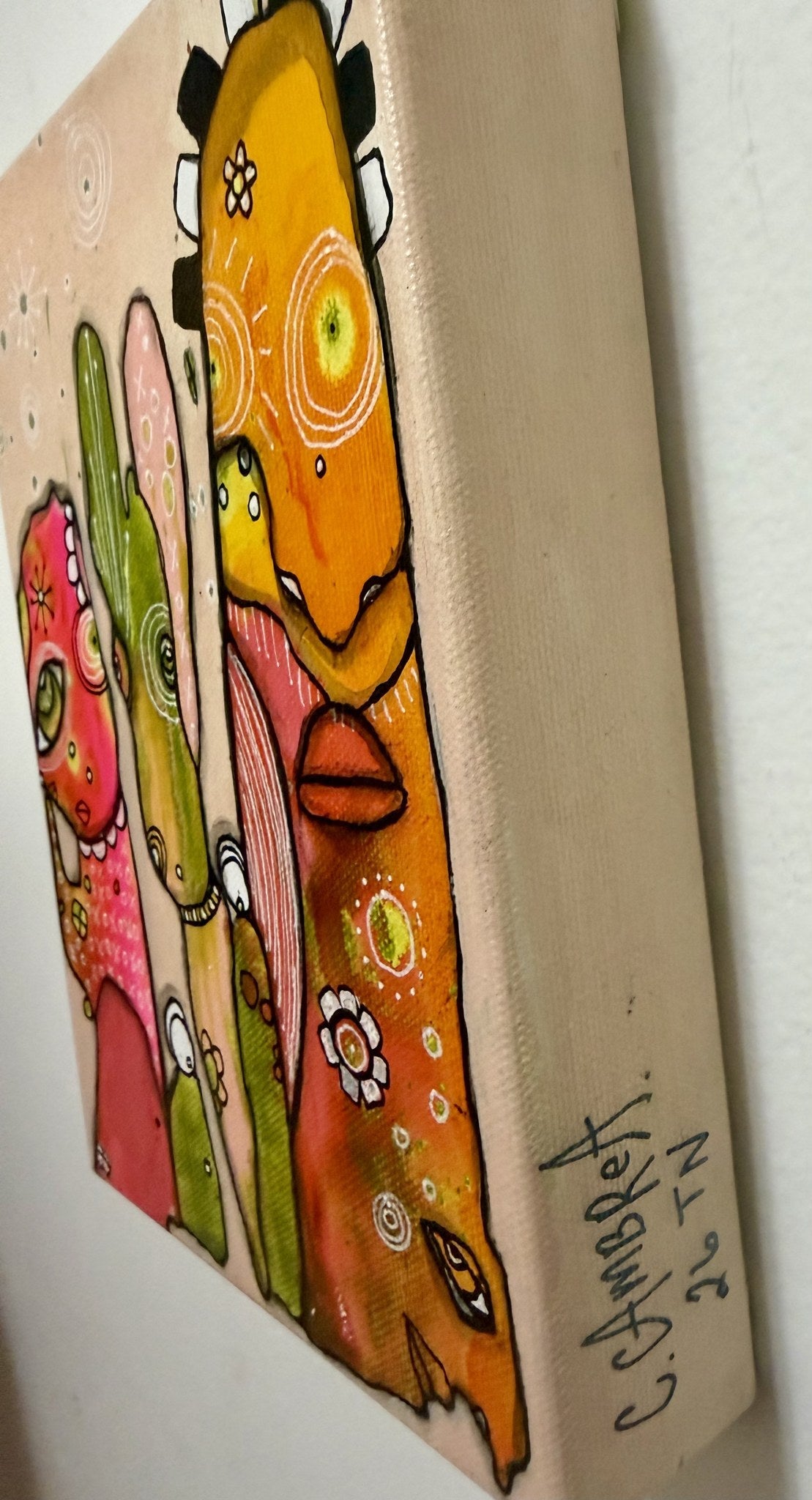 Angled side view of the canvas showing its depth, gallery-wrapped edge, and the artist's signature and date.