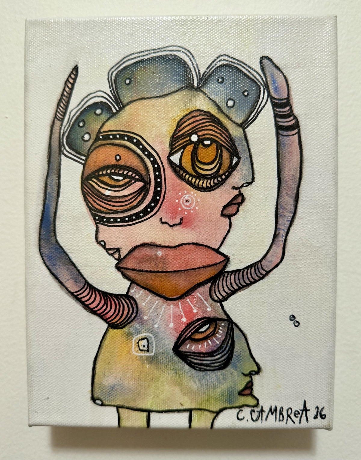Front view of the surreal mixed media artwork showing a hidden second face with a striped eye below
