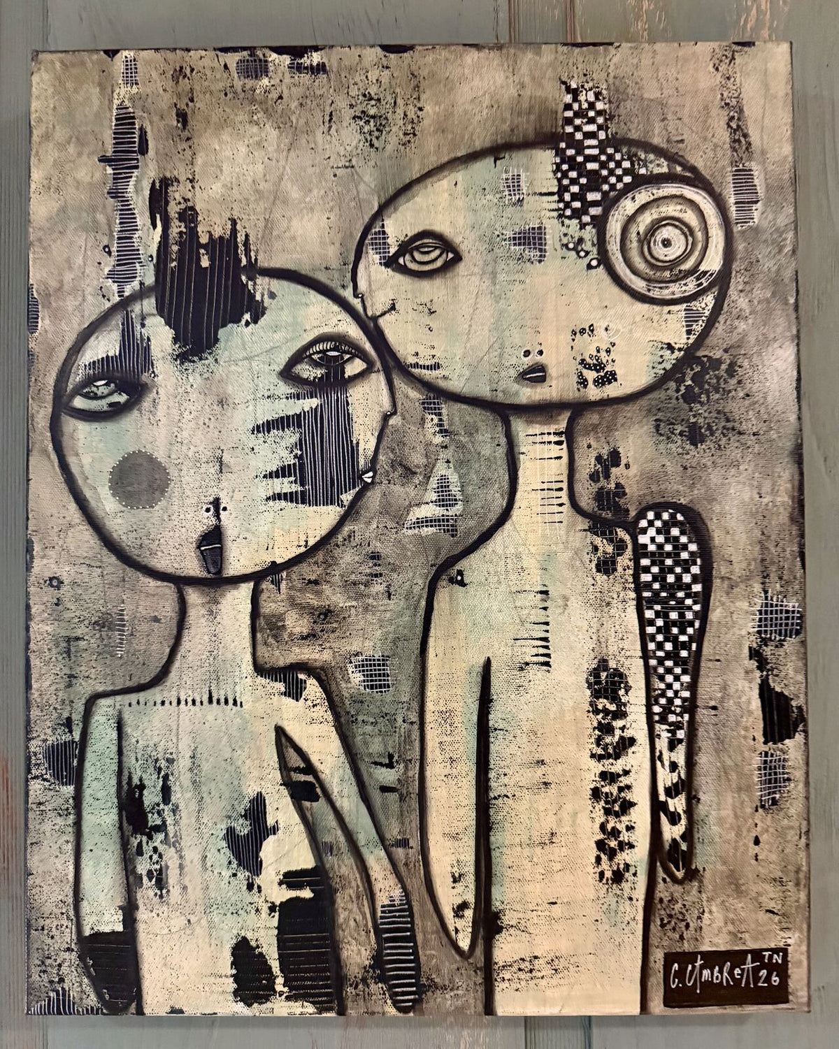 Full front view of "We Meet Again" mixed media painting showing two figures with faces close together against a textured neutral-toned background