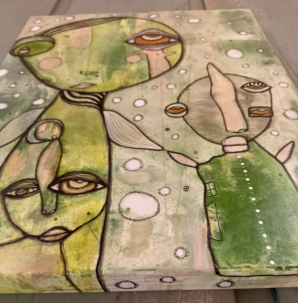 Full angled view of "Connected" showing both faces and the canvas depth