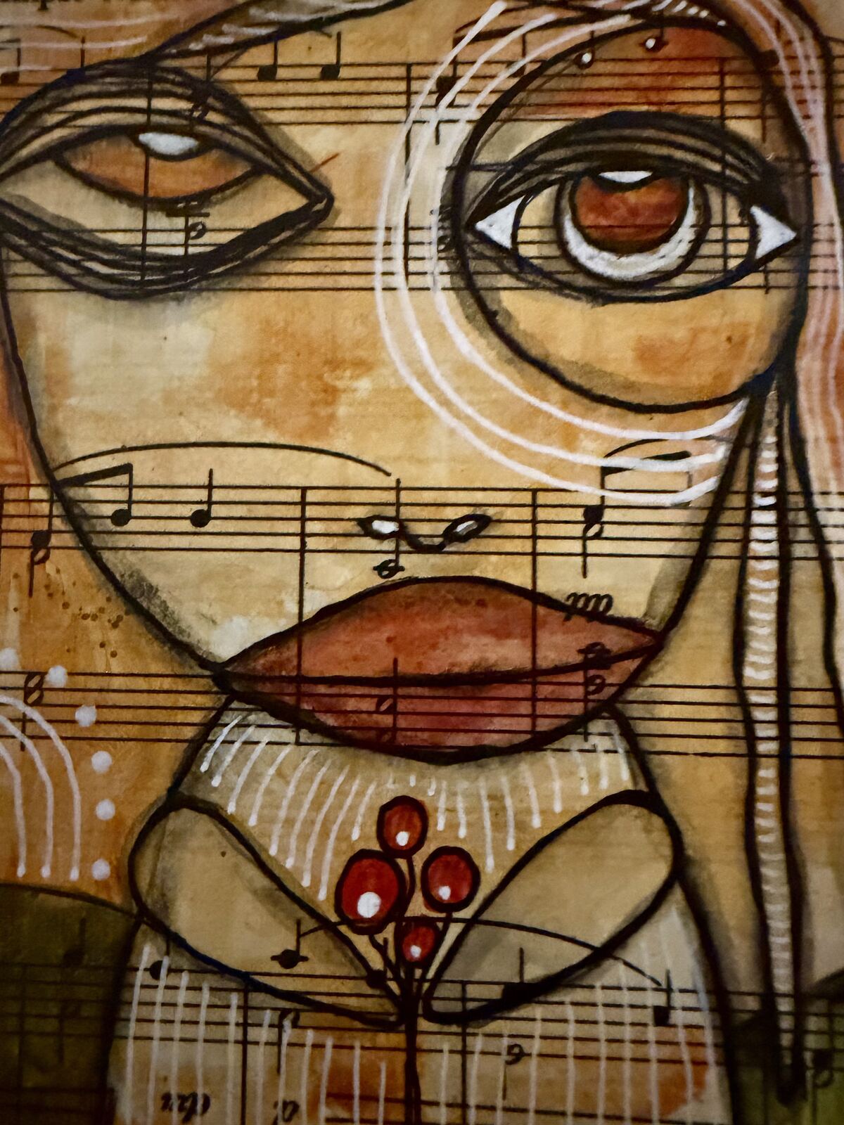 Close-up detail of the face and eyes in "To A Wild Rose", showing the sheet music collage texture