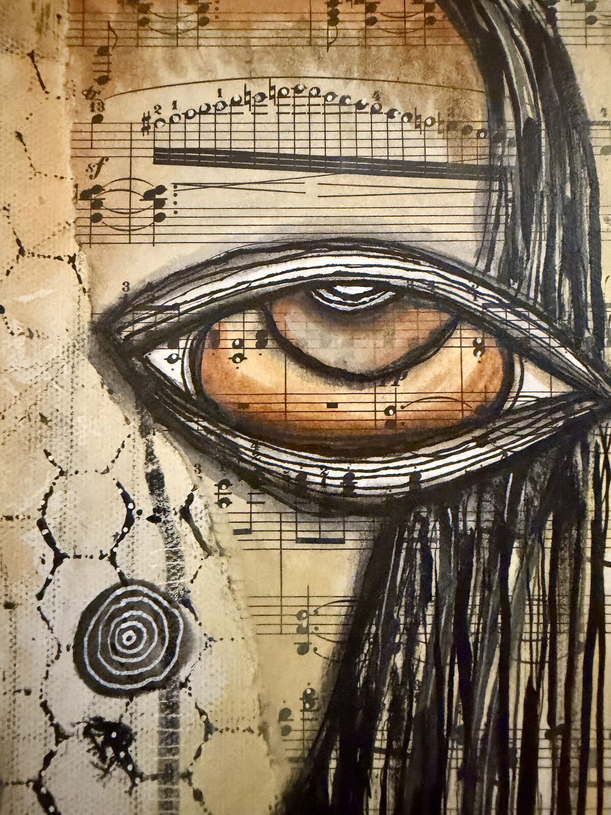 Close-up detail of the eye and sheet music collage in "Welcome"