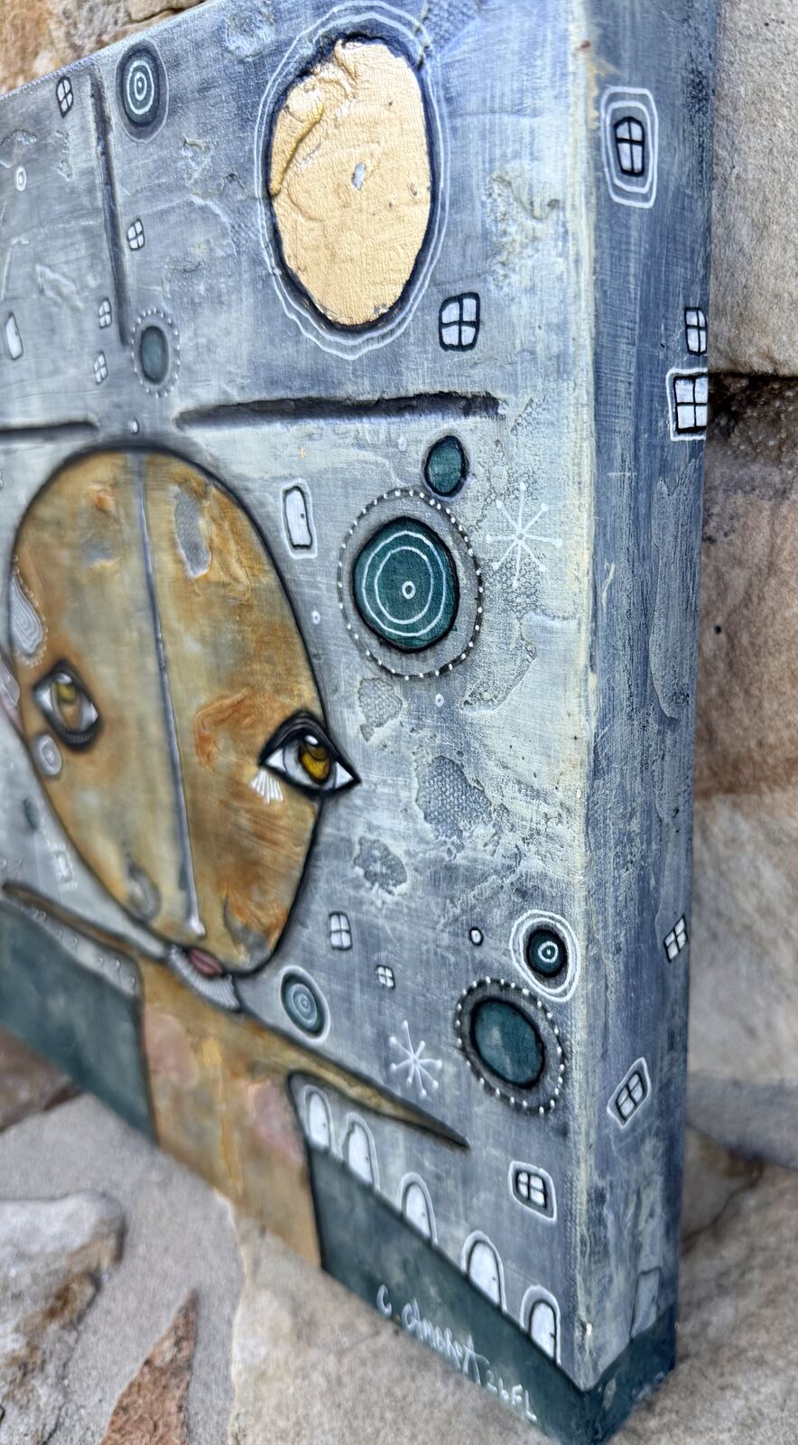 Angled side view of "Under The Moon" showing the golden face and canvas edge