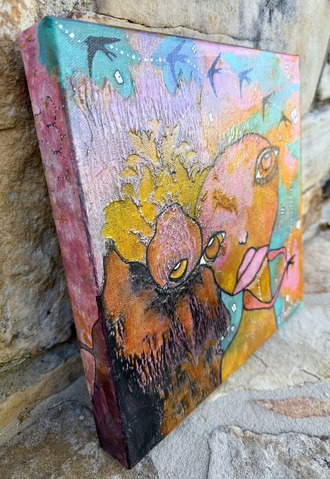 Angled side view of "My Rock" showing the pink geode companion and flying birds on the canvas edge