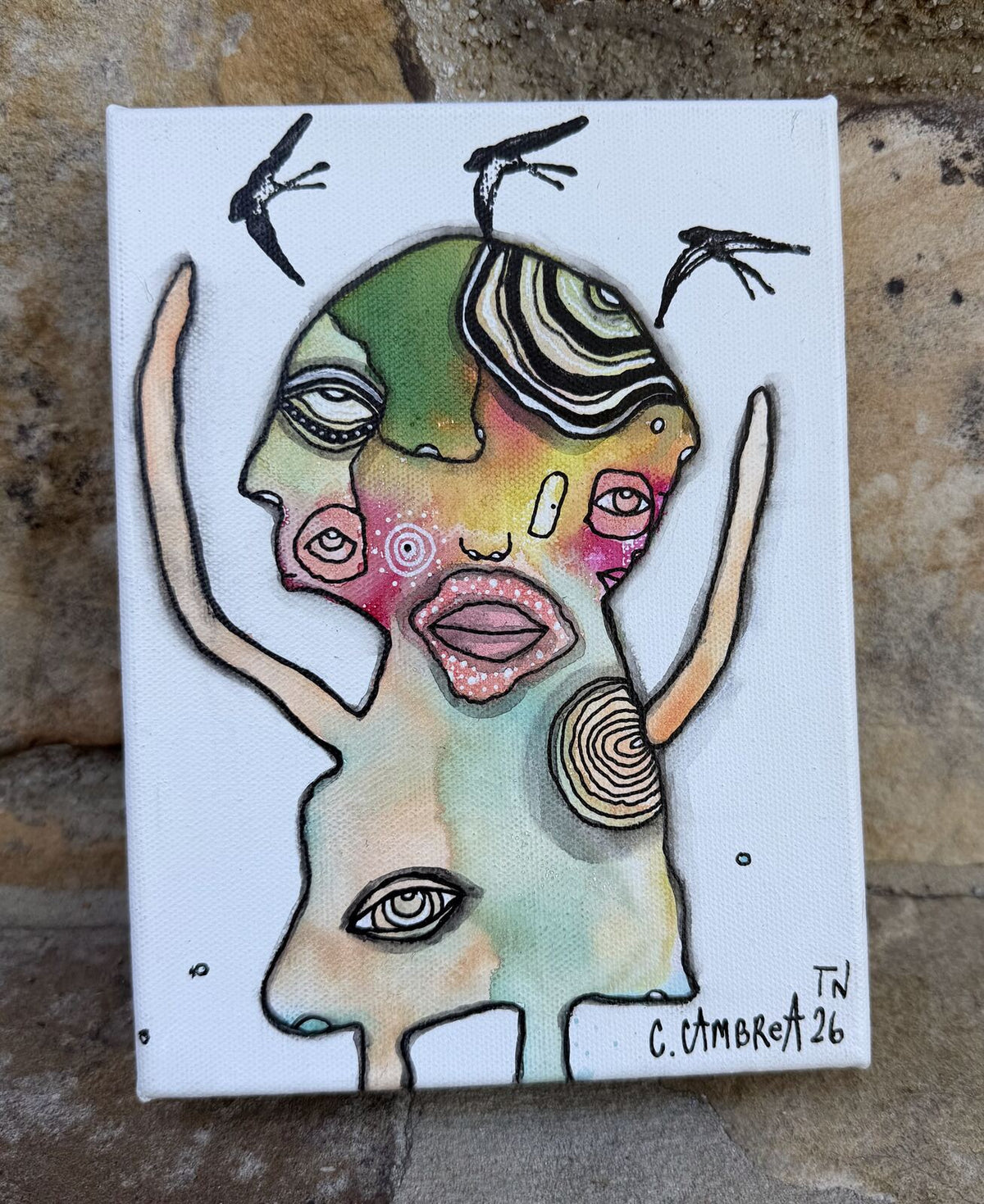Full front view of "Let Them Fly" mixed media painting showing a figure with raised arms, multiple eyes, and birds in flight overhead