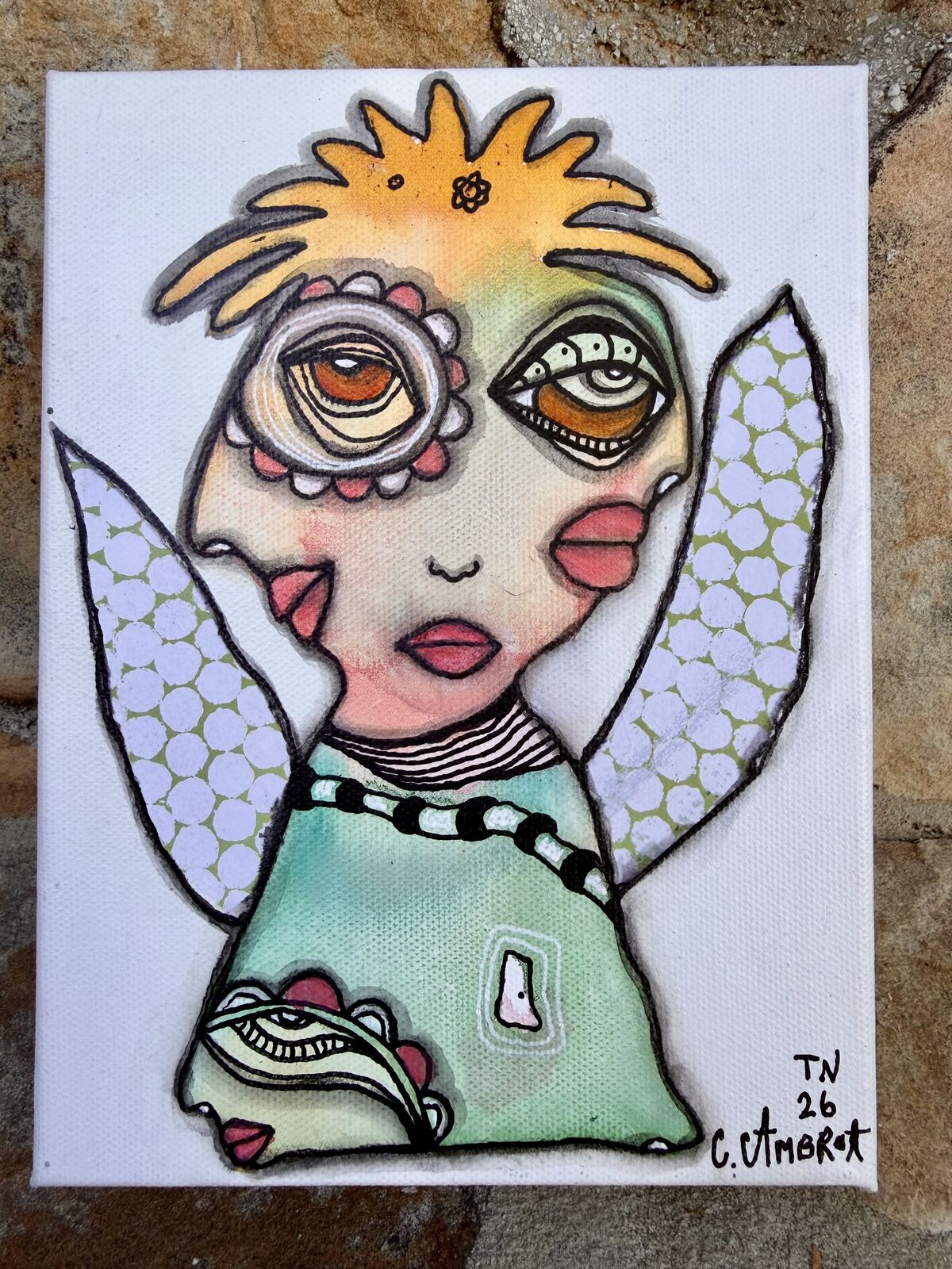 Full front view of "I See What I See" mixed media painting showing a winged figure with patterned paper collage wings and a flower-eye detail